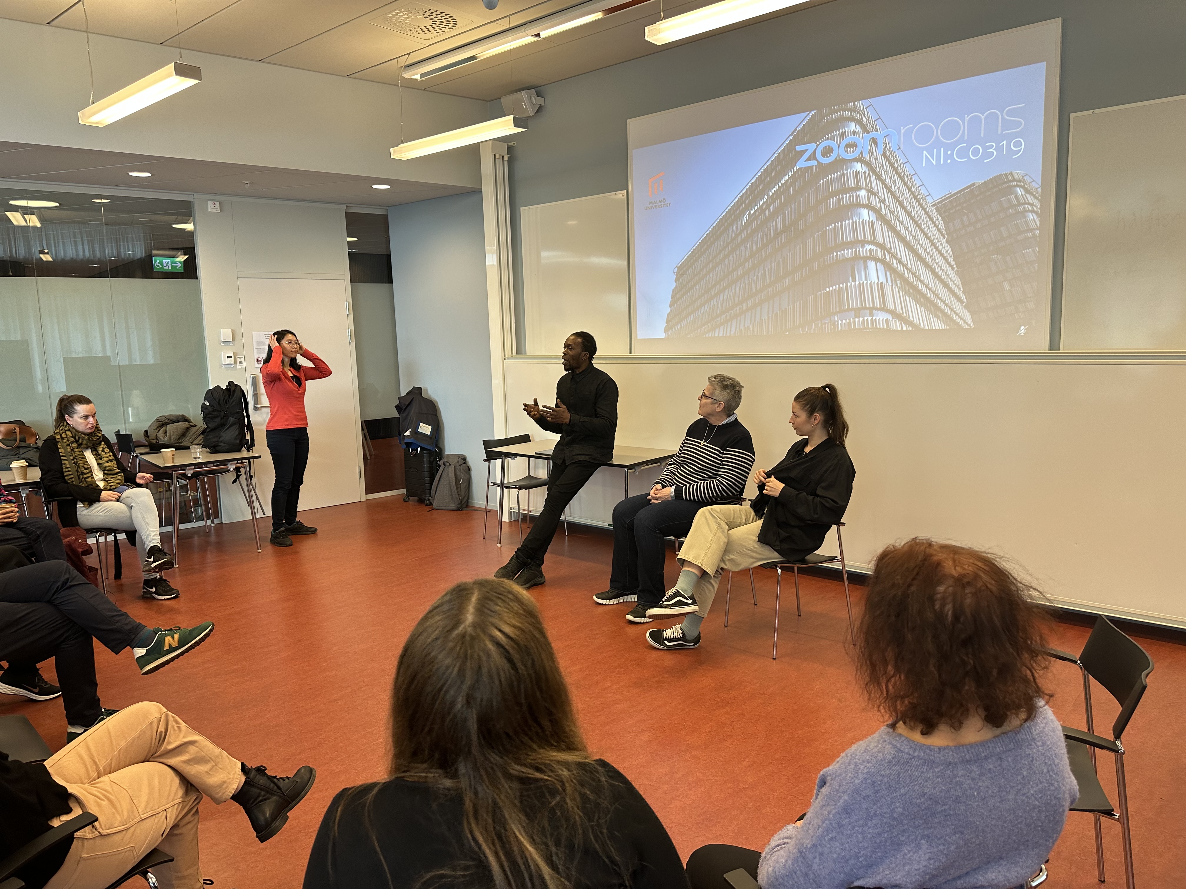 Remi Tawoshe facilitating a Forum Theatre workshop with adult professionals in a university setting